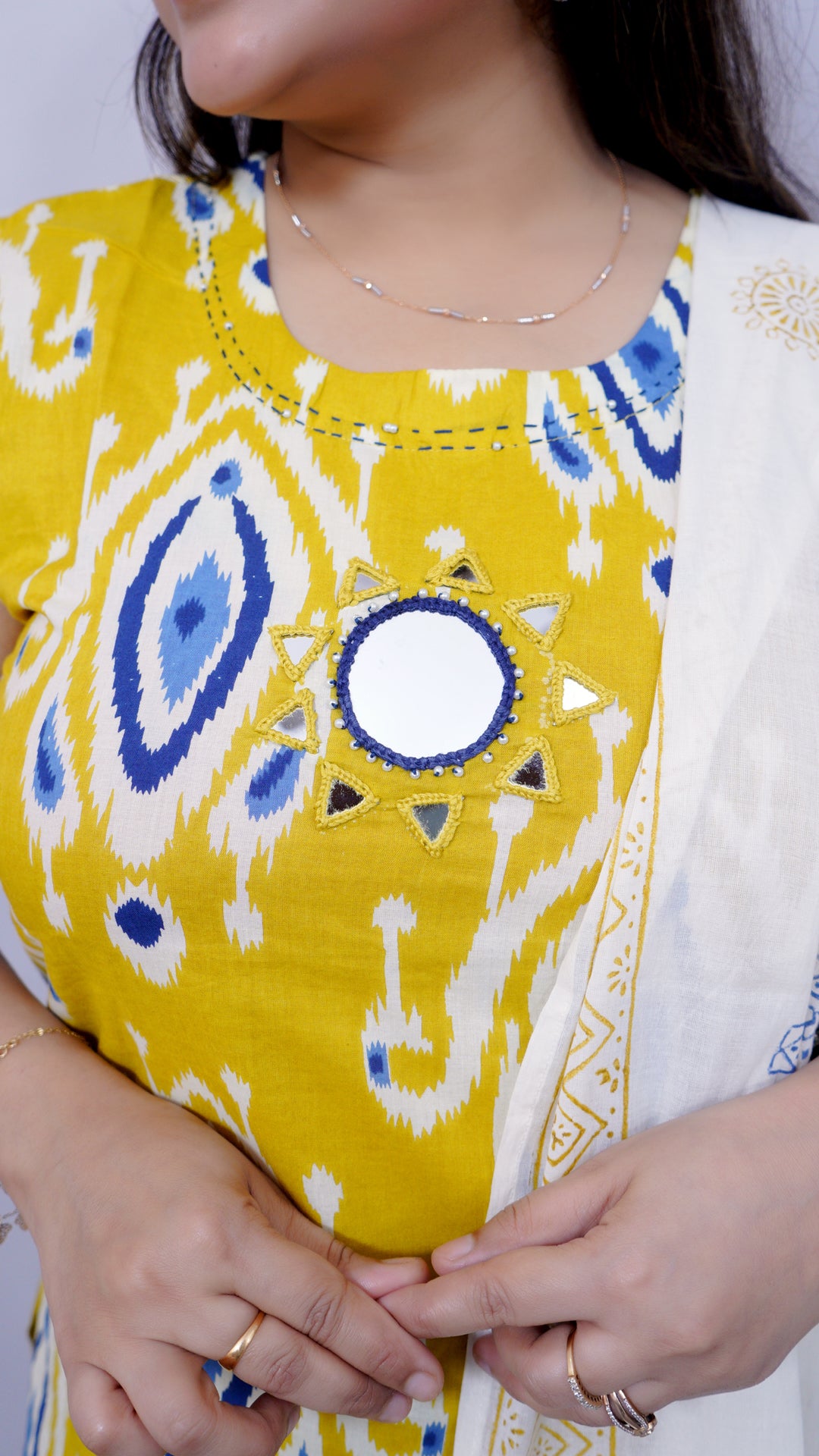 Neckline detail of yellow-white ikat print cotton suit set